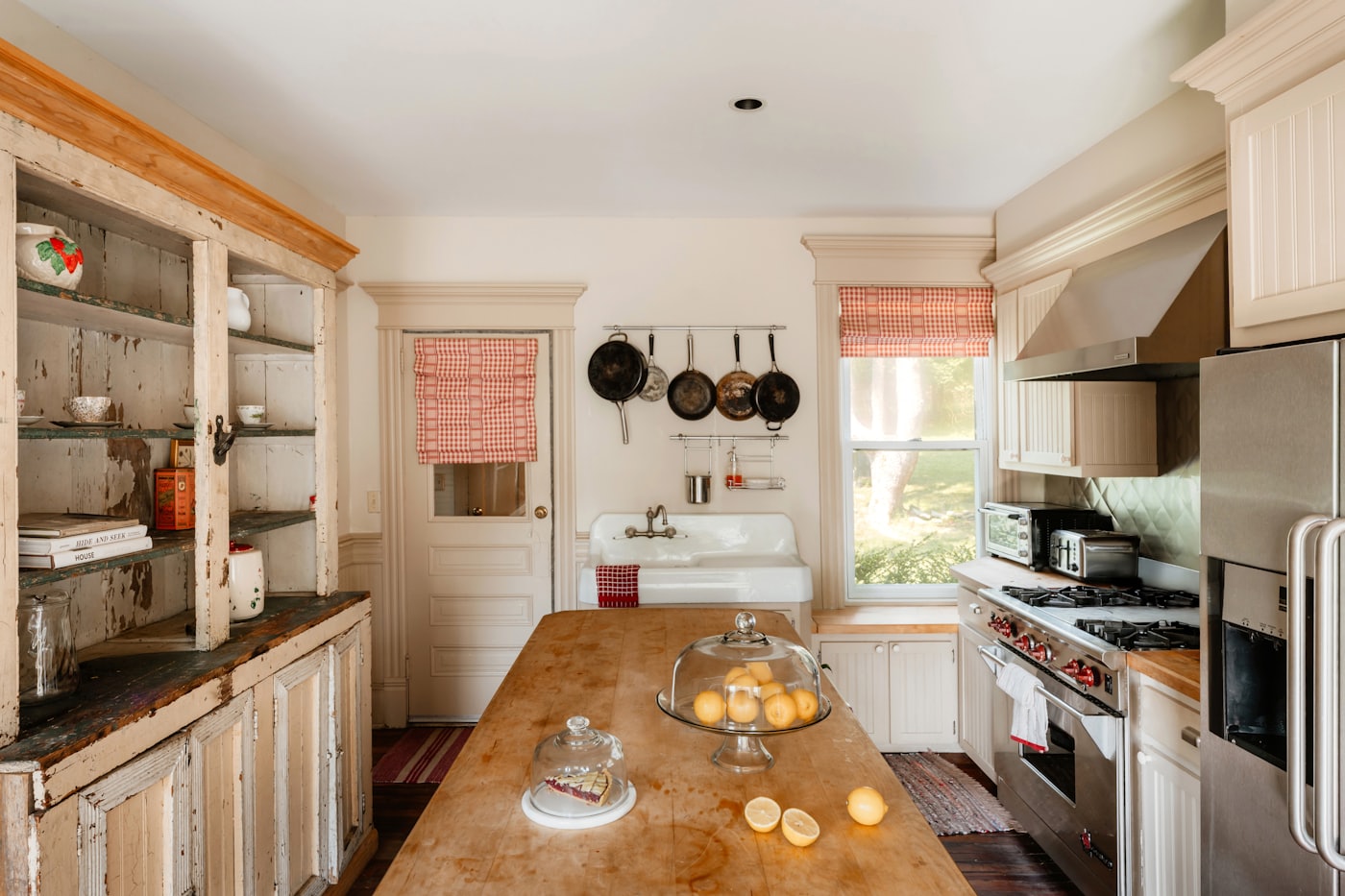 Rustic kitchen with butcher block island and vintage cabinetry